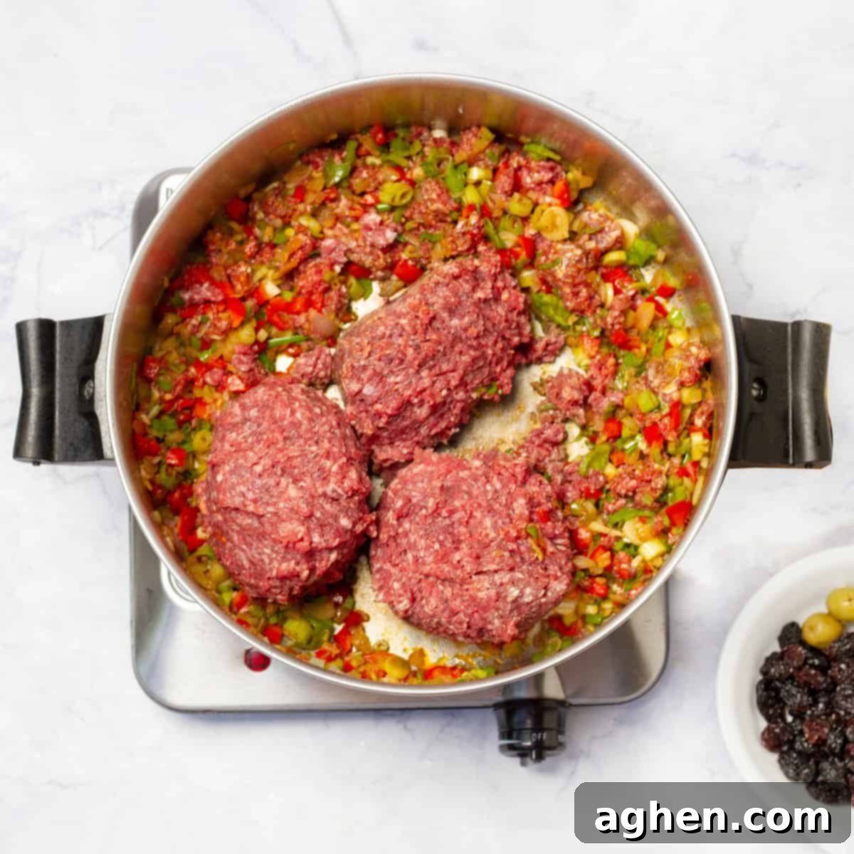 Add the ground beef to large skillet over medium heat with onion, garlic and bell pepper