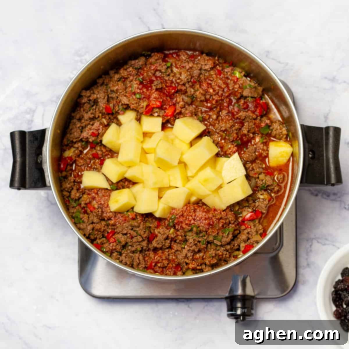 Added potatoes to Cuban Picadillo in large skillet