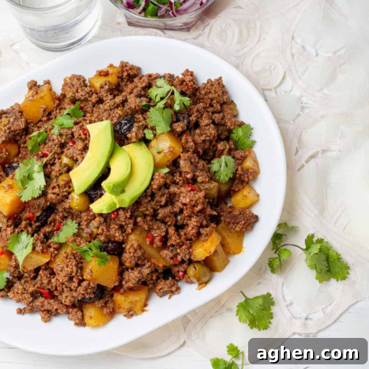 Cuban Picadillo served in a dish with dressing of Avocados slices