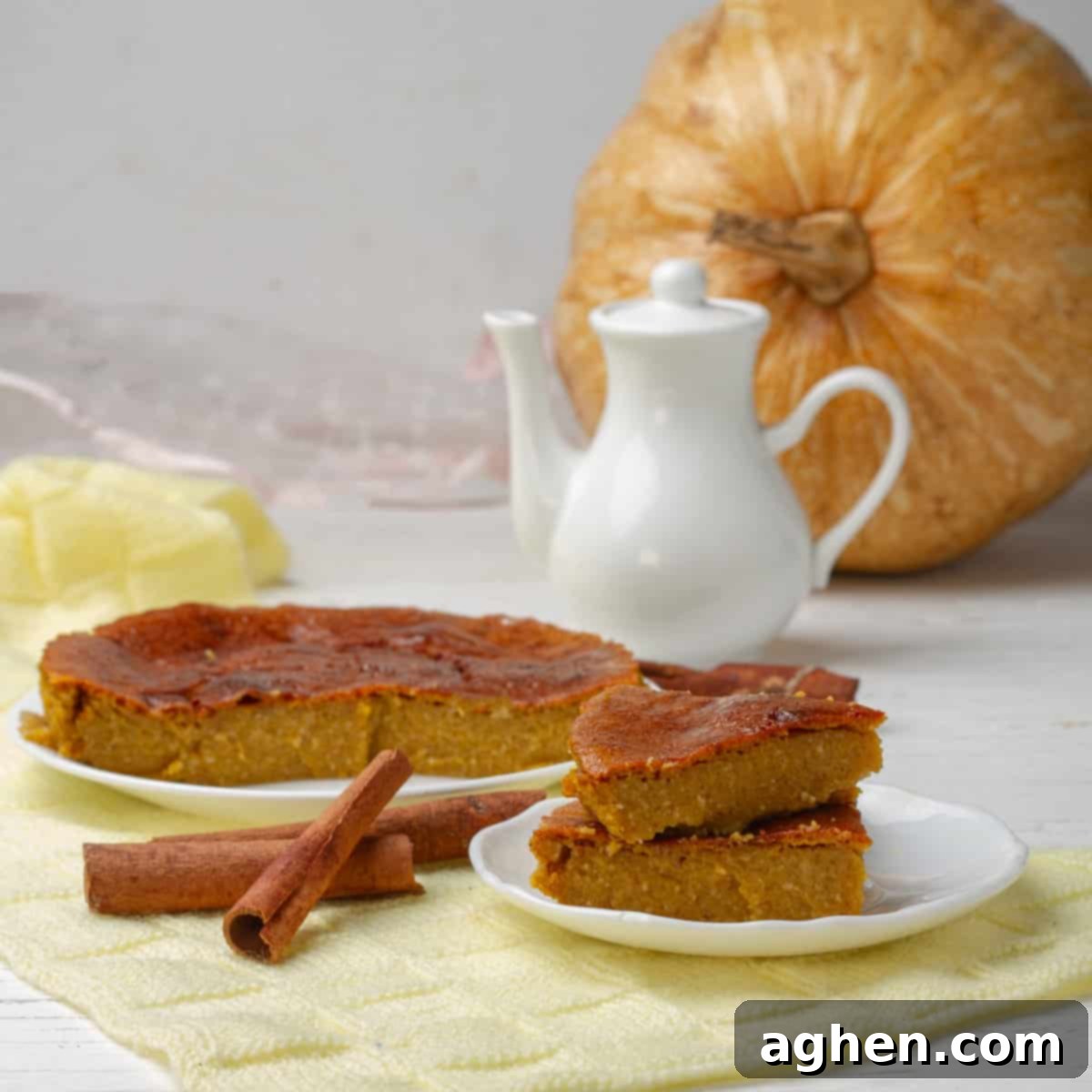 Guilt-Free Pumpkin Cake for Weight Watchers 2 Delightful Skinny Pumpkin Cake for Weight Watchers, elegantly displayed with fresh pumpkin, aromatic cinnamon sticks, and a charming teapot in the background, perfect for a cozy autumn treat.