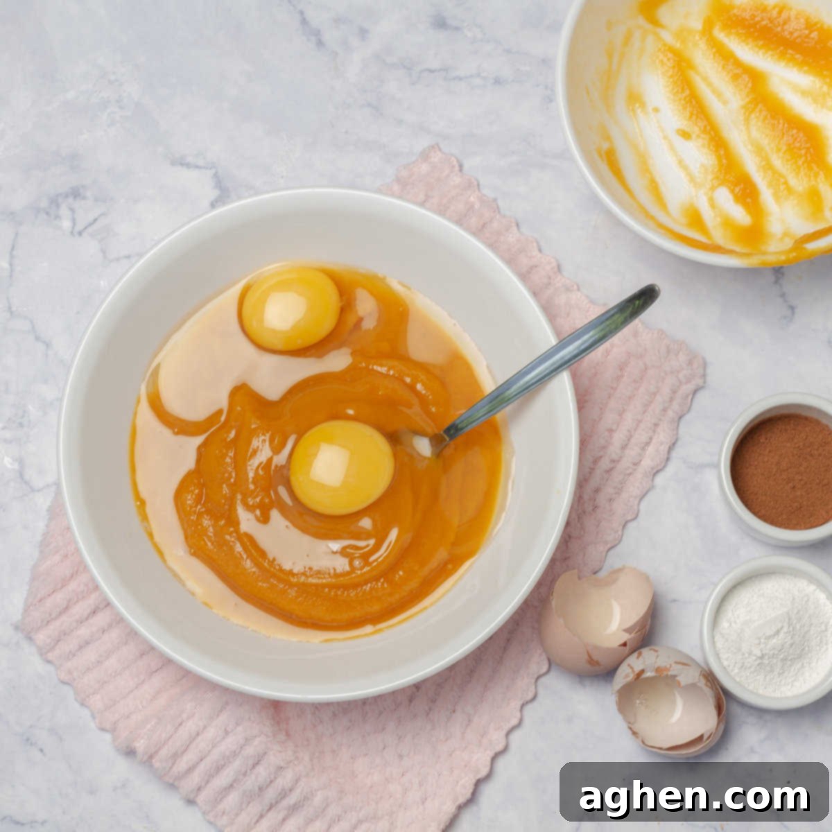 Guilt-Free Pumpkin Cake for Weight Watchers 4 Wet ingredients for Skinny Pumpkin Cake: pumpkin puree and eggs being combined in a bowl, showing the initial mixing step.