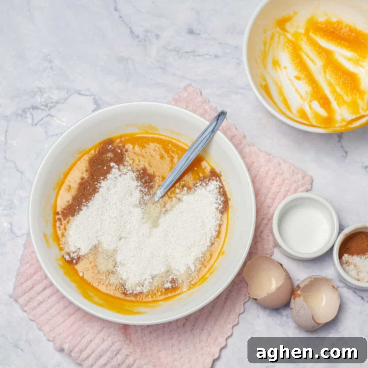 Guilt-Free Pumpkin Cake for Weight Watchers 5 Dry and wet ingredients for Skinny Pumpkin Cake being combined in a bowl, demonstrating the mixing process for the batter.