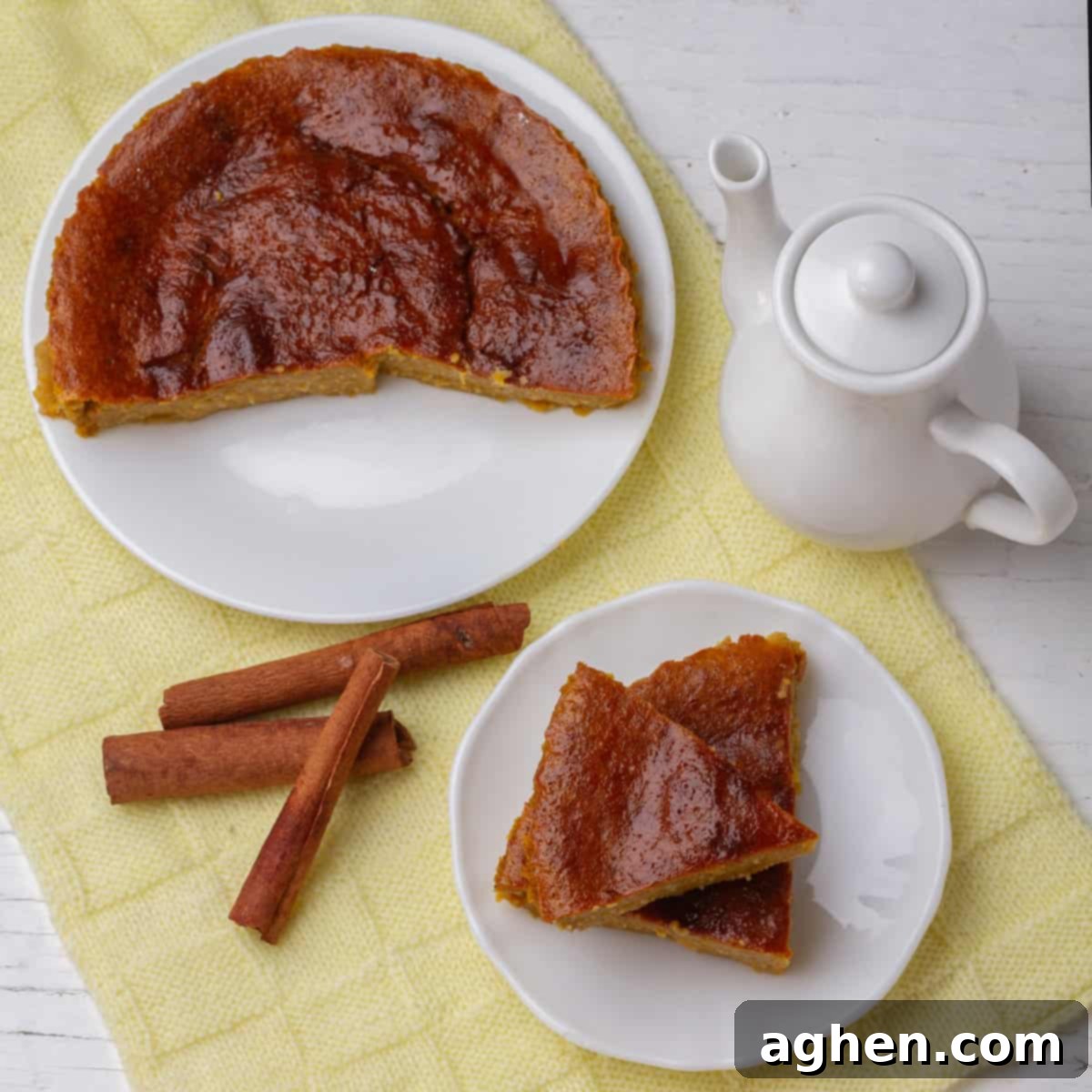 Guilt-Free Pumpkin Cake for Weight Watchers 6 A beautifully baked Skinny Pumpkin Cake, garnished with cinnamon sticks and a teapot, ready to be served as a delightful and healthy dessert.
