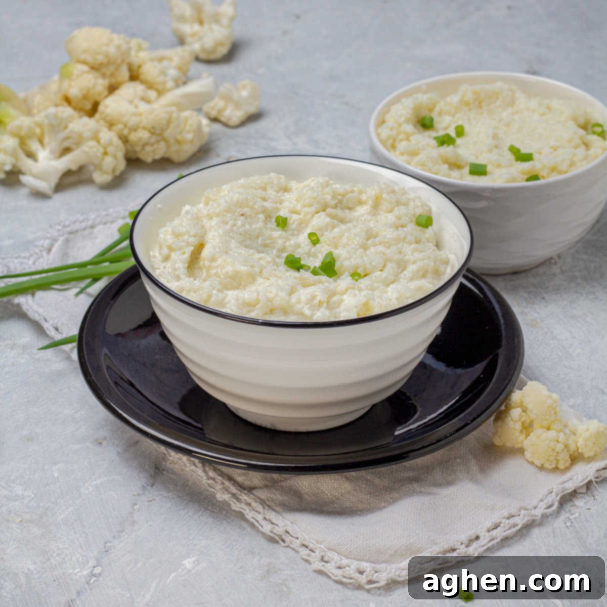 The Zero Point Mashed Cauliflower I Make On Repeat 7 Close-up of Mashed Cauliflower in a bowl, showing its creamy texture and garnished with fresh herbs.