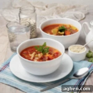 Zero Point Minestrone: Your Cozy, Guilt-Free Chilly Day Essential 8 Two Minestrone Soup bowls served with fresh herbs.