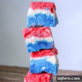 A stunning block of Red, White, and Blue Marshmallow Creme Fudge, perfectly layered and ready to be enjoyed. This easy no-bake dessert is a hit for any patriotic holiday.