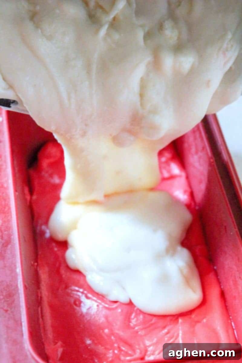 Step 4: The colored fudge mixtures are carefully layered into the prepared pan, starting with red, then white, then blue.