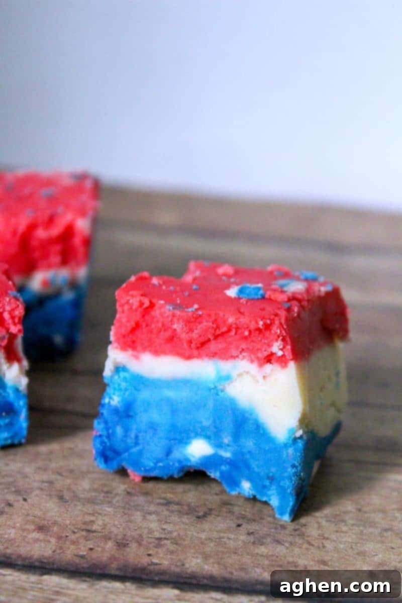 A beautiful block of Red, White, and Blue Marshmallow Creme Fudge, perfectly set and ready to be sliced for a 4th of July celebration.