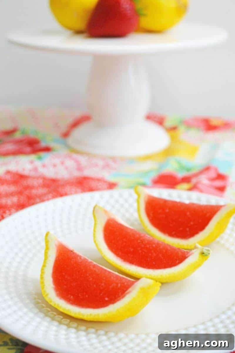 Strawberry lemonade jello shots made with vodka and served in lemon wedges. Don't be fooled -- these lemon wedge jello shots are actually very easy to make!