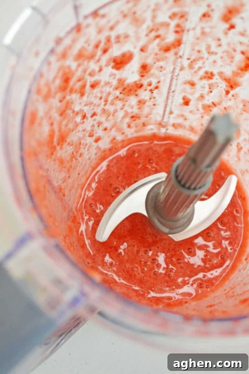 Blended strawberries for strawberry lemonade jello shots.
