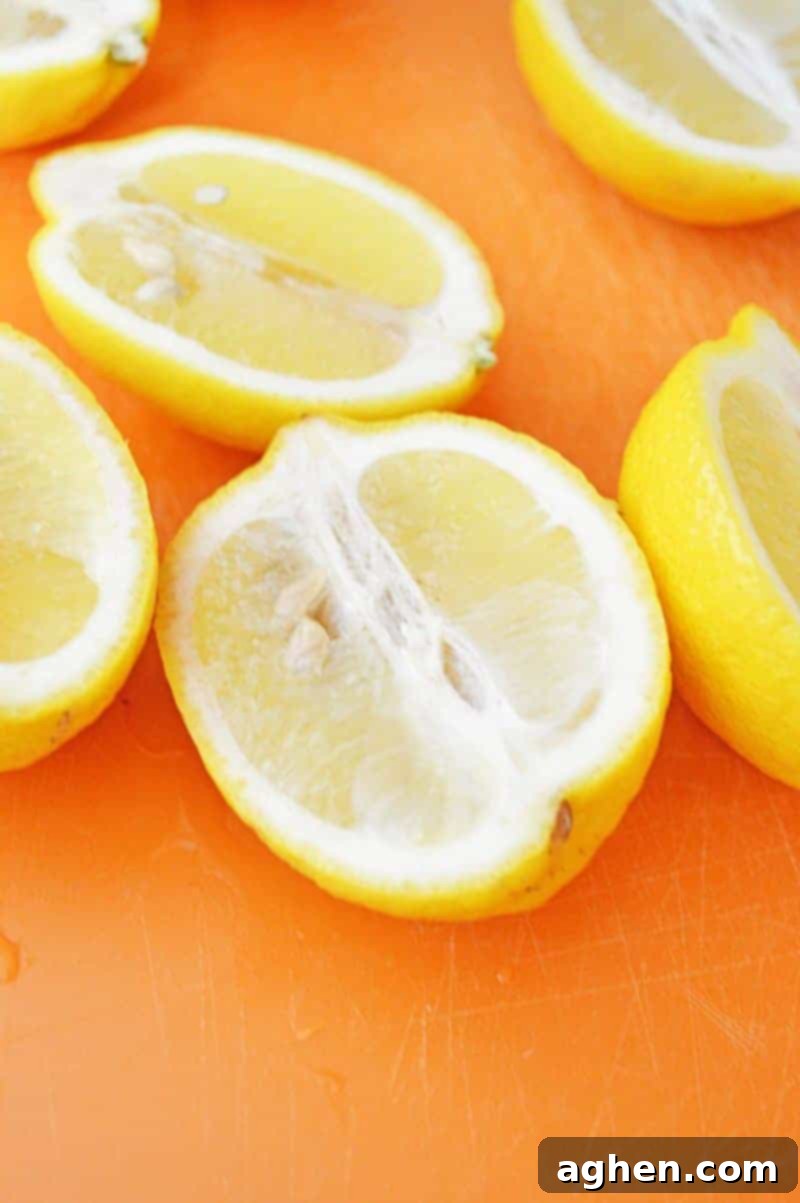 Lemons sliced in half, ready to be hollowed out for jello shots.