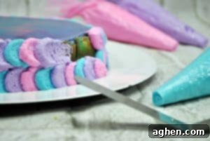 Decorating the Unicorn Cheesecake with colorful whipped cream, creating a petal effect.
