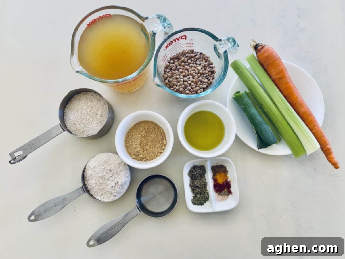 Various vegan lentil loaf ingredients laid out: uncooked lentils, vegetable broth, flax meal, water, rolled oats, oat flour, diced carrot, celery, leek, avocado oil, and an assortment of seasonings.