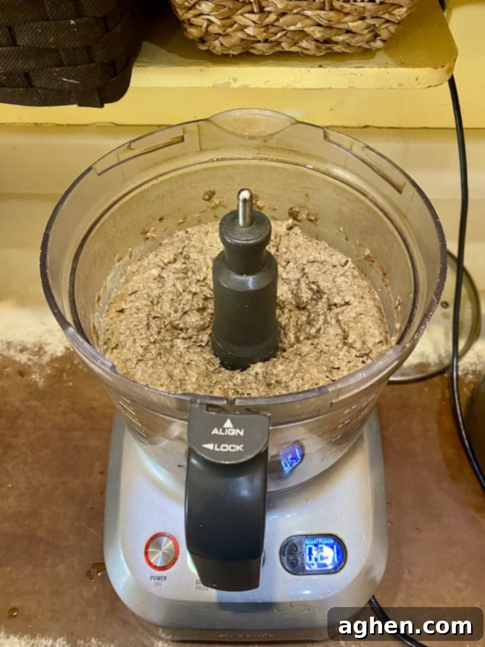 Two-thirds of the cooked lentils being mashed in a bowl, while one-third remains whole.