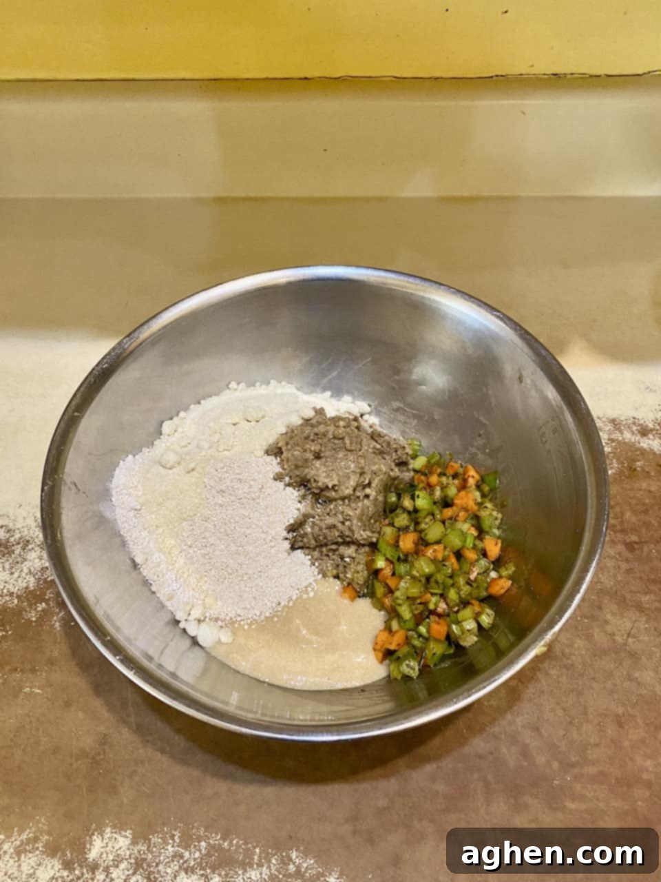 All the lentil loaf ingredients (lentils, sautéed veggies, oats, flour, flax egg) mixed thoroughly in a large bowl.