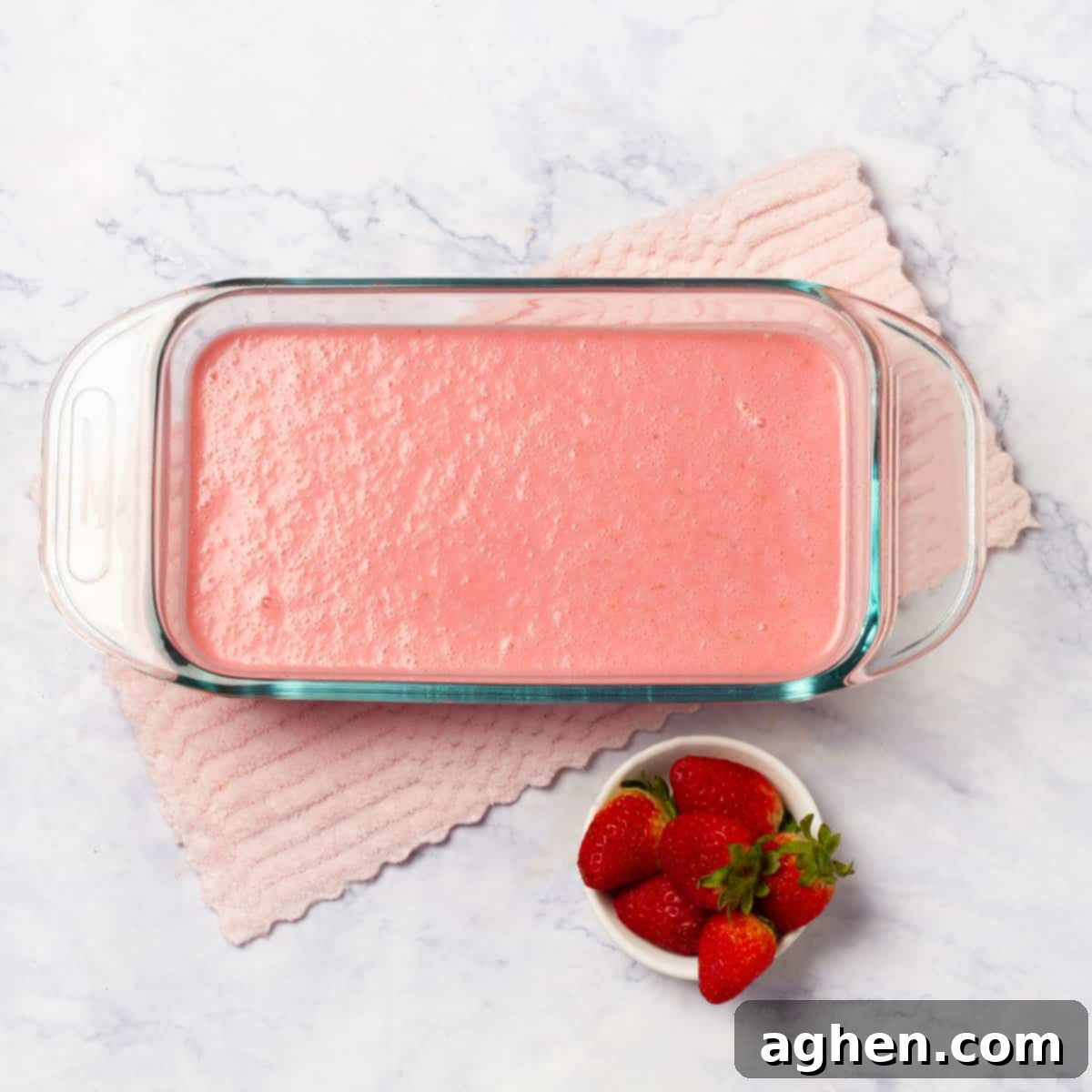 Frozen Strawberry Yogurt Mixture Being Scraped in a Bowl