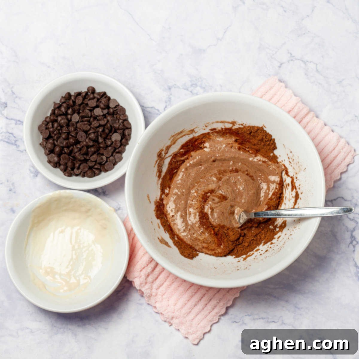 In a large bowl, mash the bananas and cocoa powder