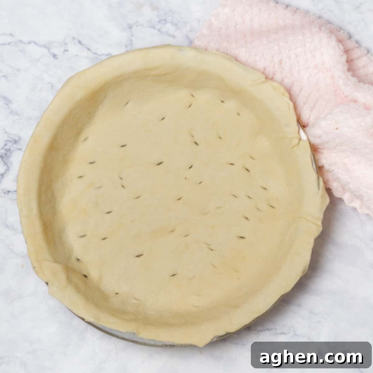 Warm Up Cold Nights with a Hearty Beef Pie 7 The bottom pie crust carefully placed into a pie dish, with small vents poked for even baking.