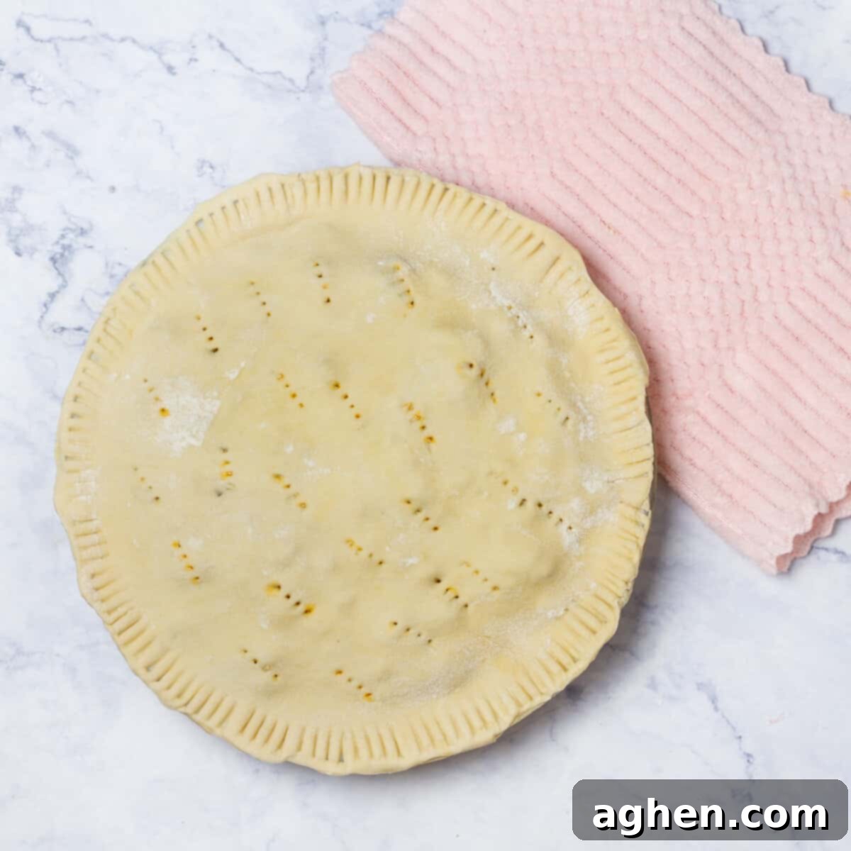 Warm Up Cold Nights with a Hearty Beef Pie 9 The top pie crust carefully placed over the filling, creating a complete pie ready for the oven.
