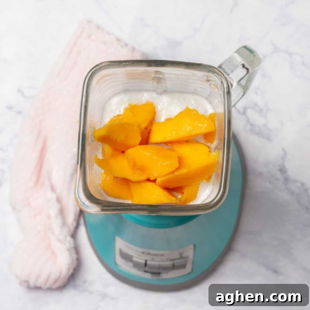 Tropical Mango Coconut Delight 4 Creamy Mango and Coconut Ice Cream ingredients being combined in a blender.