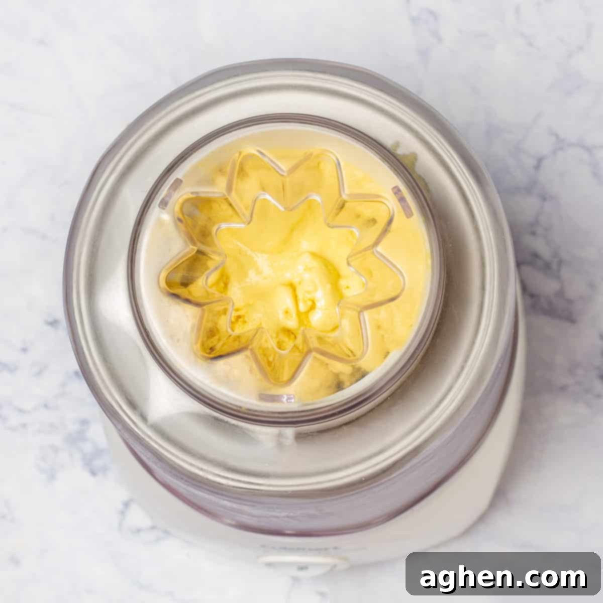 Tropical Mango Coconut Delight 7 Scraped Creamy Mango and Coconut Ice Cream mixture transferred to an ice cream maker for churning.