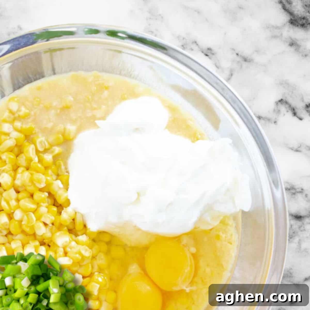 My Weight Watchers Jiffy Corn Casserole Recipe 5 All the Jiffy corn casserole ingredients in a clear mixing bowl, ready to be stirred.