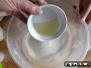 Slowly and carefully add the liquid ingredients to the dry ingredients, mixing as you go.