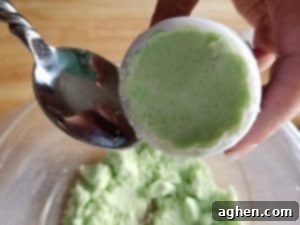 Pack the bath bomb mixture firmly into the moon cake press mold.