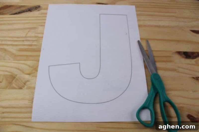Carefully cut out the letter J template from the printed paper.