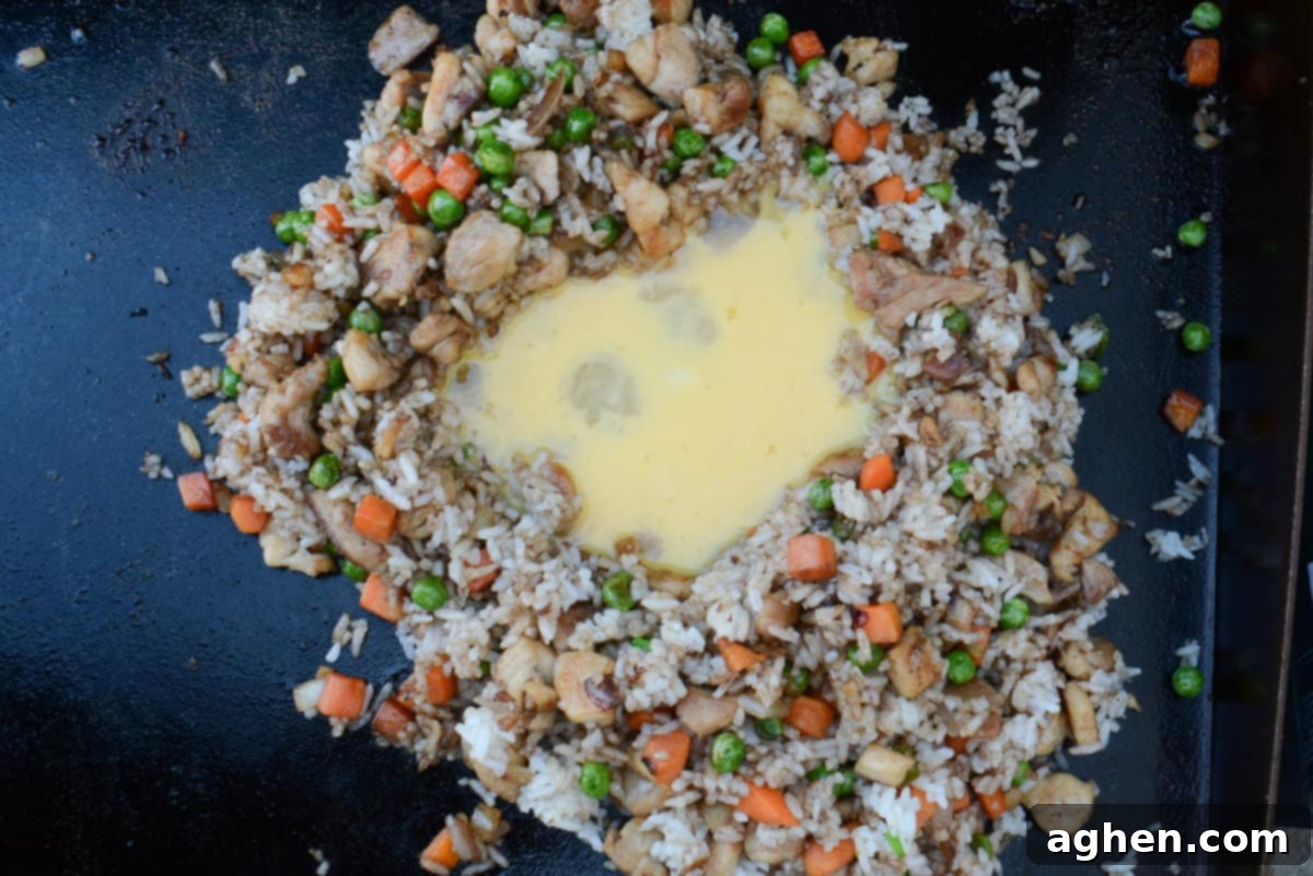 Ultimate Blackstone Chicken Fried Rice 11 adding egg to blackstone chicken fried rice