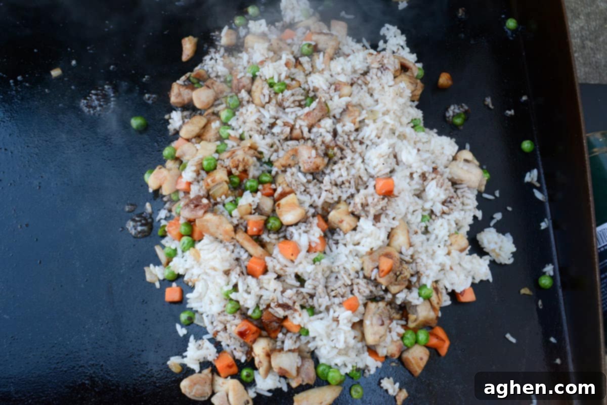 Ultimate Blackstone Chicken Fried Rice 10 chicken fried rice, cooking on blackstone
