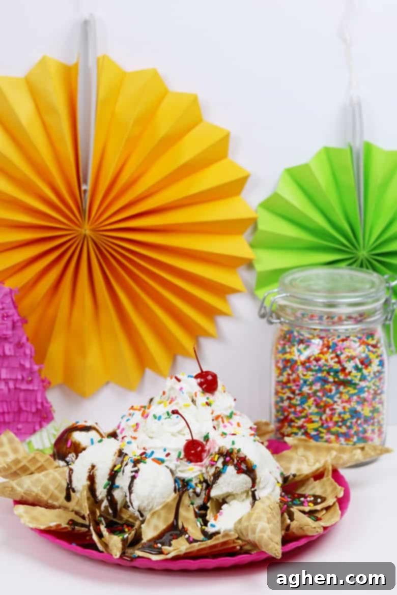 A delightful platter of ice cream nachos sundae with a container of rainbow sprinkles ready to be added, showcasing the fun customization options.