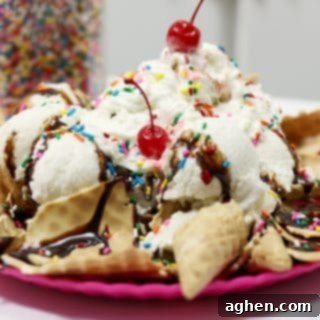 Ice cream sundae on top of a bed of broken ice cream cones.