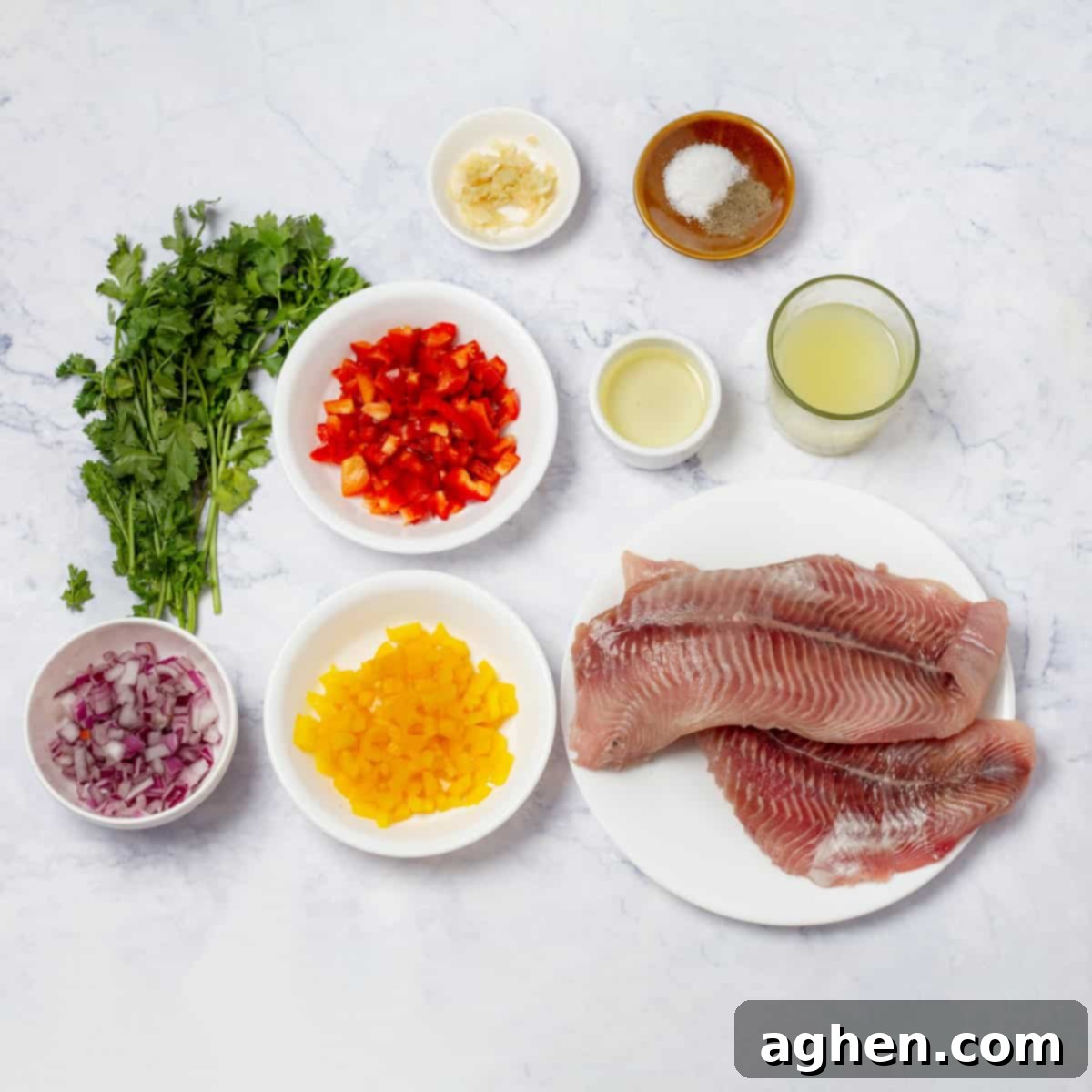 A vibrant selection of fresh ingredients laid out for ceviche preparation, including diced hake, sliced red onion, and chopped bell peppers.