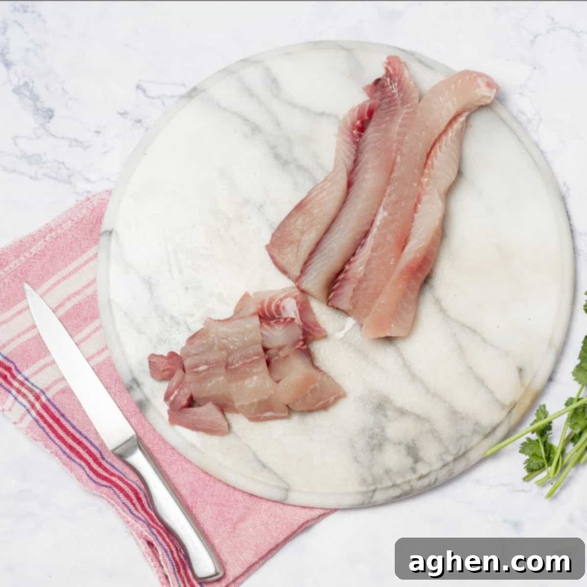 The hake fillets diced into uniform, bite-sized pieces, showing the preparation for optimal marination and flavor absorption.