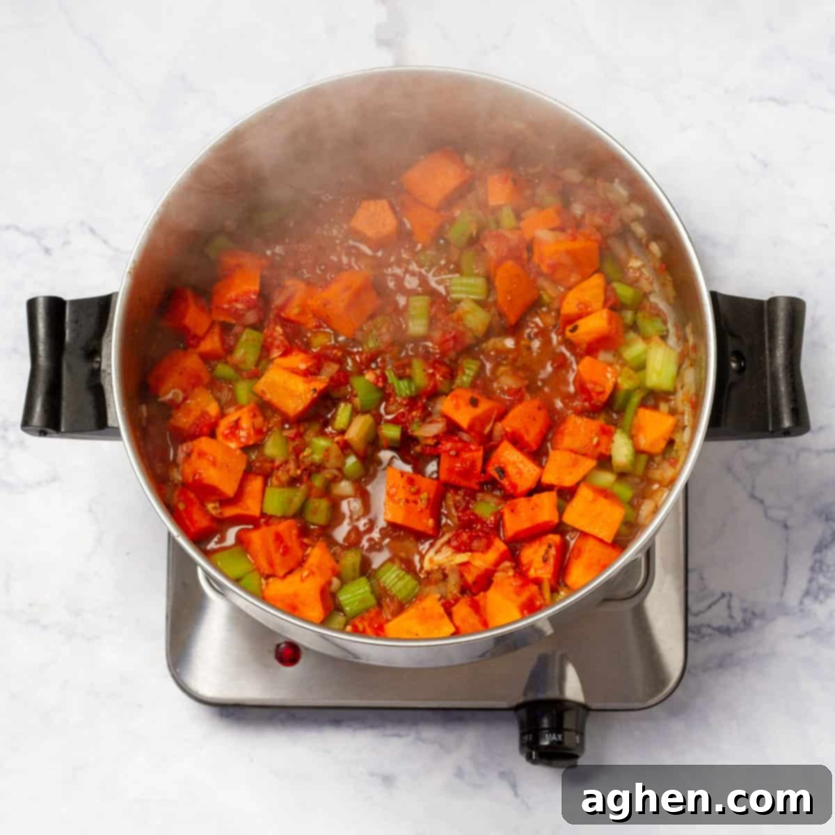 Grated tomato and passata being stirred into the sautéed vegetables in a pot