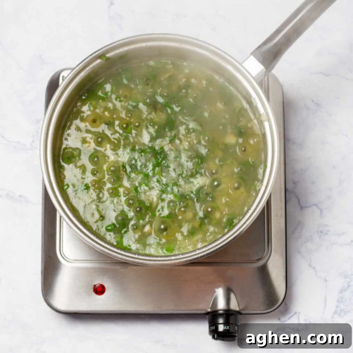 Romantik Akşamların Yıldızı: Yeşil Soslu Berlam 7 Simmering fish broth, peas, and herbs in a pot to create a flavorful base
