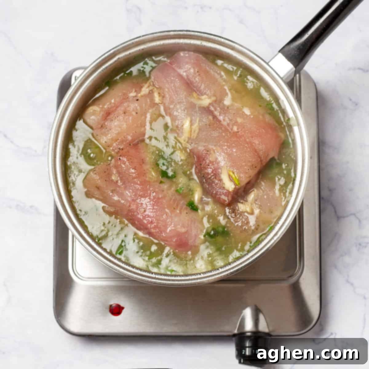 Romantik Akşamların Yıldızı: Yeşil Soslu Berlam 8 Marinated hake fillets cooking in the vibrant green sauce in the pot