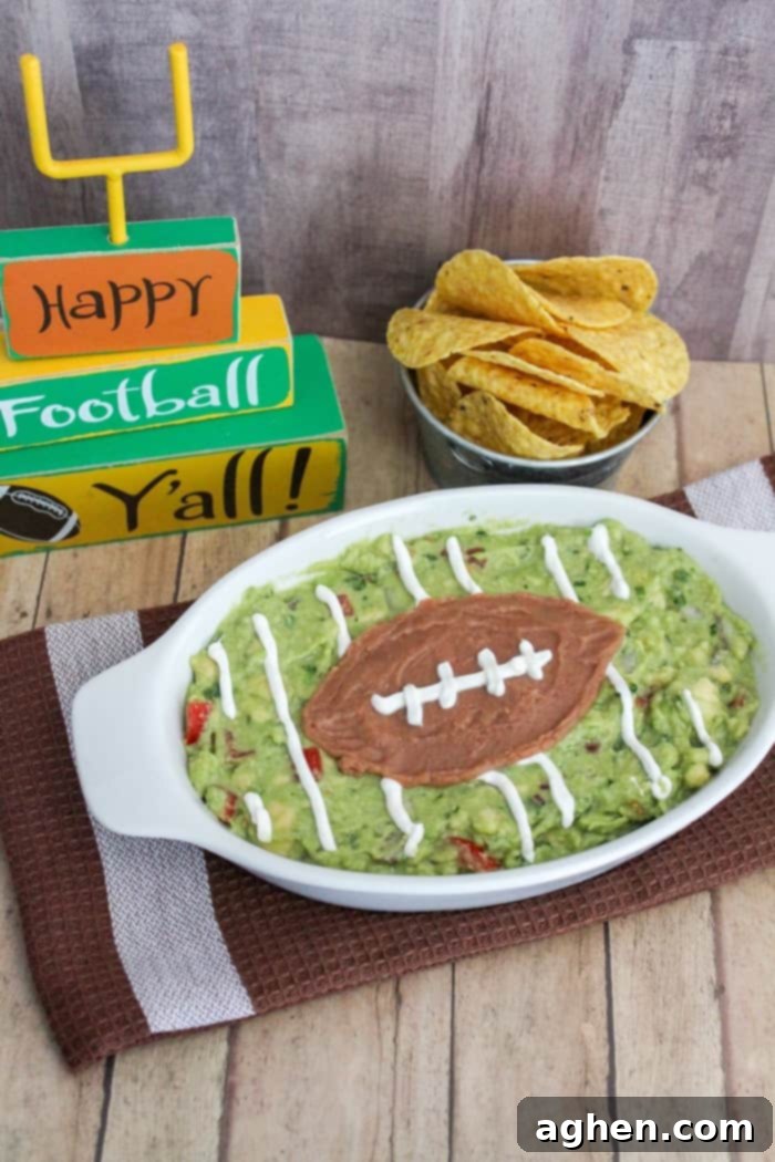 Easy homemade guacamole recipe for game day, freshly prepared and ready to be turned into a football field appetizer.