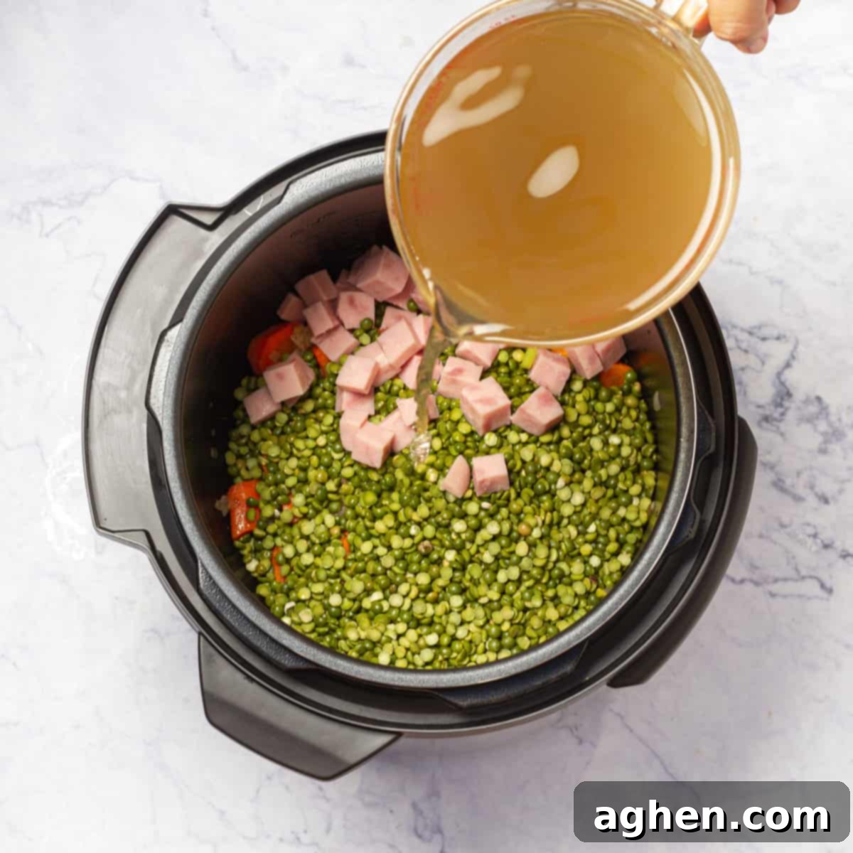 Rinsed green split peas added to the Instant Pot with sautéed vegetables, ready for broth and seasoning.