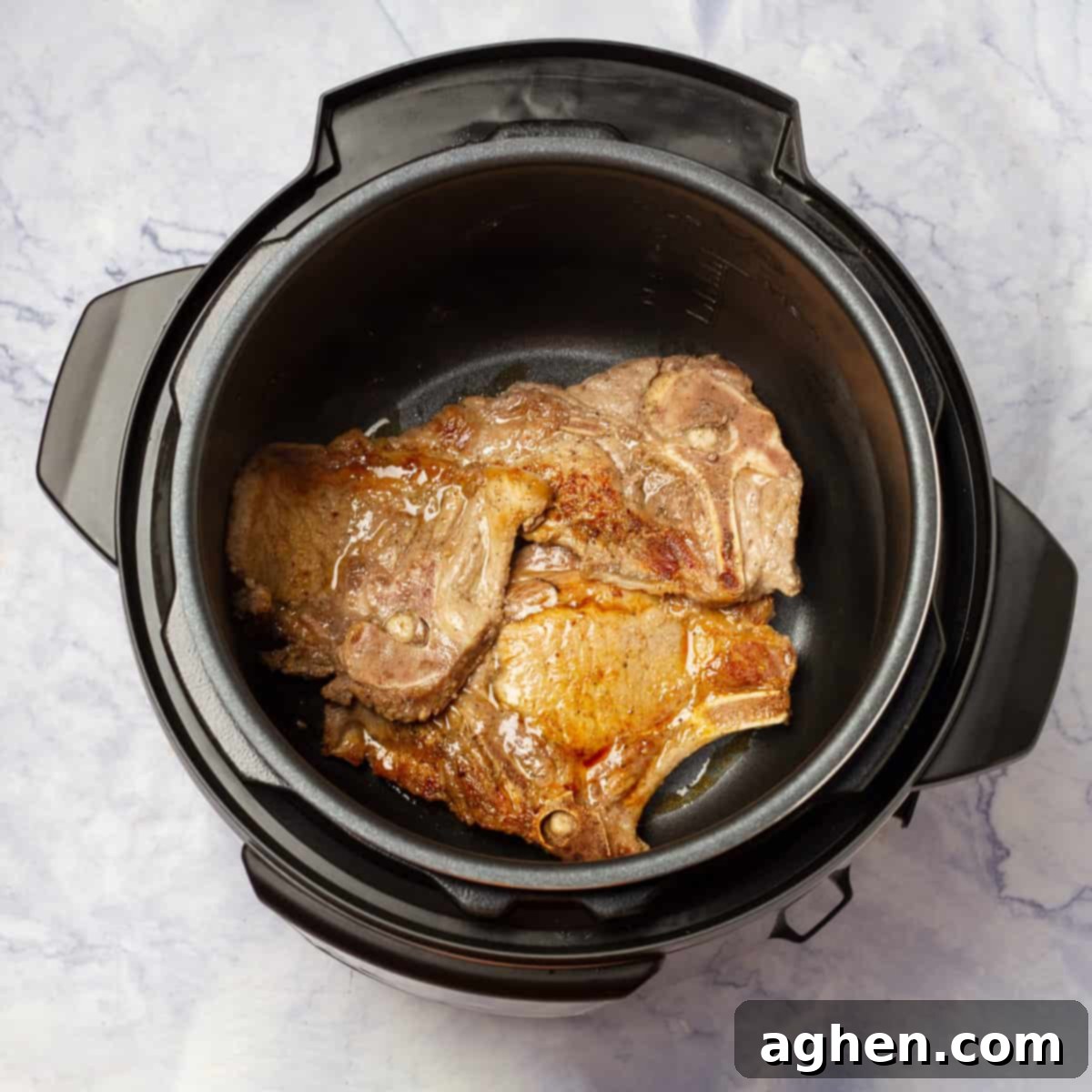 Juicy Instant Pot Pork Chops in Minutes 4 Raw pork chops seasoned with salt and pepper, ready for searing in an Instant Pot.
