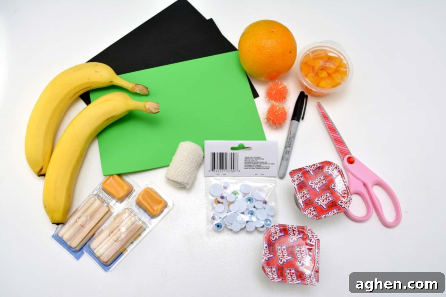Essential craft materials needed to create fun, non-candy Halloween snacks for kids, including googly eyes, craft foam, gauze, and a low-temp glue gun.