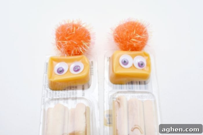 Detailed step-by-step instructions showing how to decorate a cheese and cracker package into a fun Halloween monster snack.
