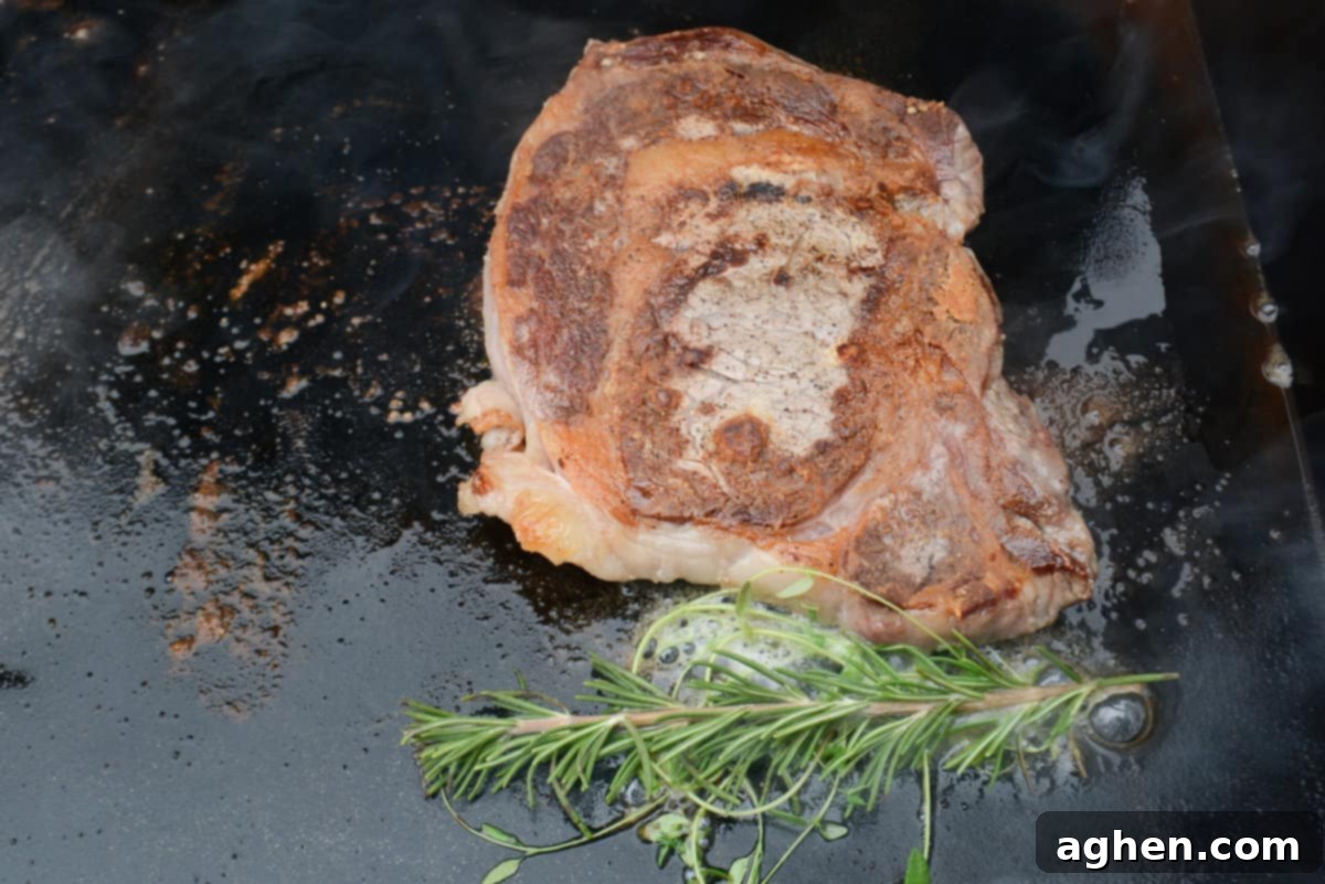 Mastering Steak on the Blackstone Griddle 8 ribeye steak with meat thermometer checking internal temperature