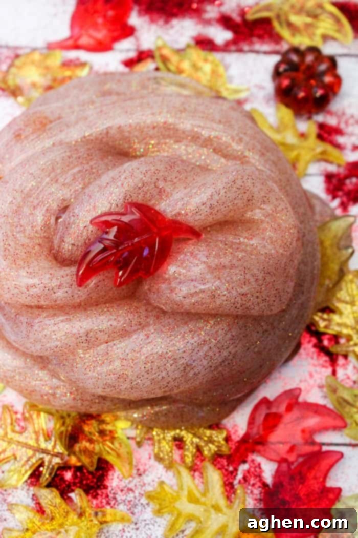 Vibrant Fall Slime with sparkling red and gold glitter, a perfect sensory and science activity for autumn.