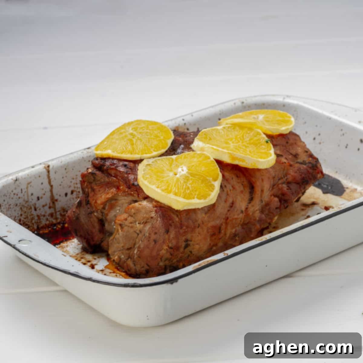 sliced pork garnished with fresh orange slices