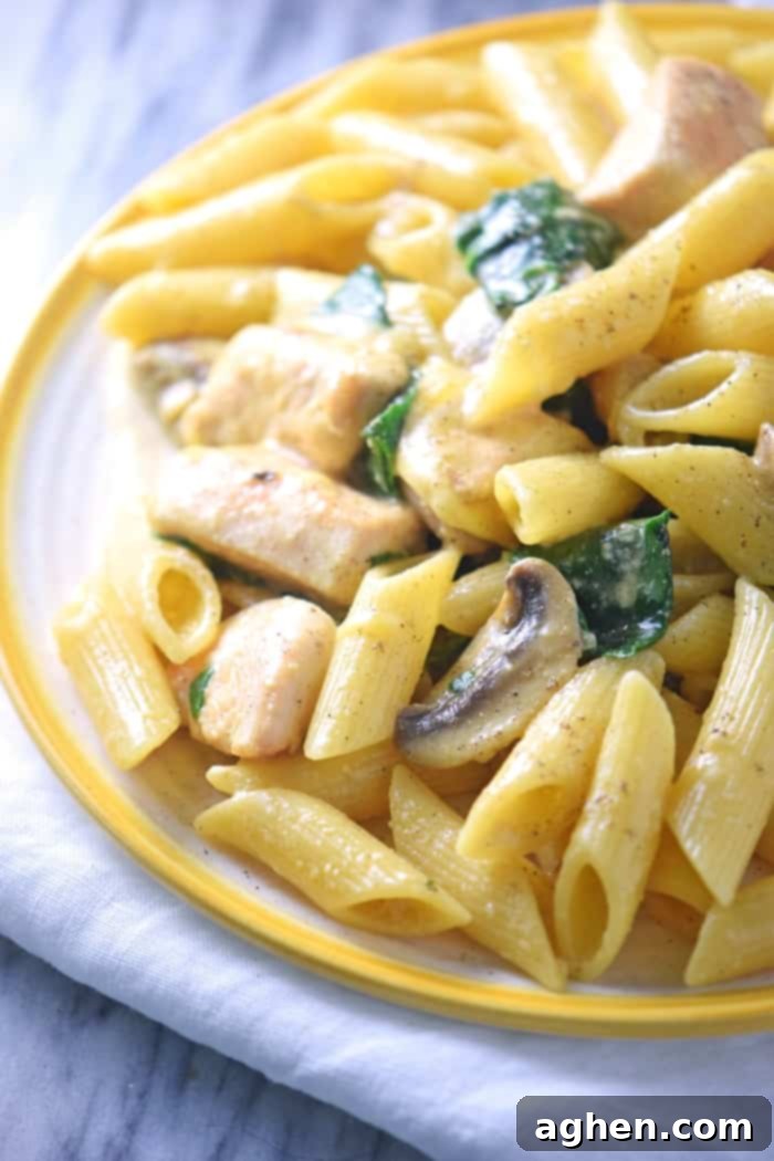 Delicious one-pot creamy spinach chicken pasta with mushrooms, ready in 30 minutes for an easy family meal