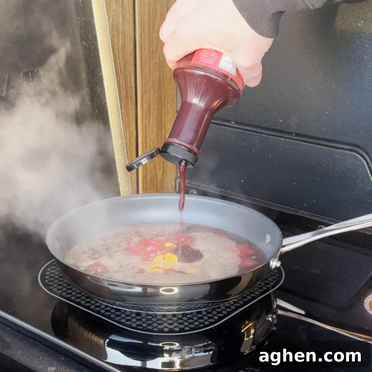 Root beer glaze simmering in a saucepan