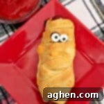 Mummy hot dogs, an easy Halloween dinner recipe, perfect for post-trick-or-treating or a spooky party.