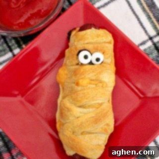 Mummy hot dogs, an easy Halloween dinner recipe, perfect for post-trick-or-treating or a spooky party.